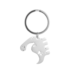 Macro view showing the polished silver dinosaur pendant with heart-shaped cutouts and shiny finish