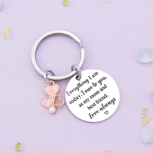 Stainless steel mom keychain with pink heart pendants and pearl on a purple background