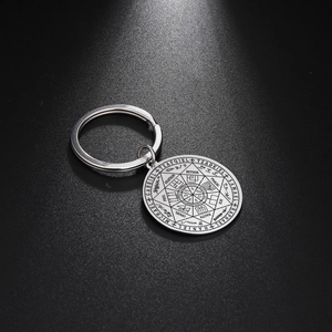 Polished stainless steel Seven Archangels sigil keychain on a sleek black background