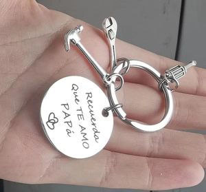 Close-up of stainless steel keychain with tools and Spanish Papa engraving held in hand
