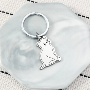 Minimalist cat shaped stainless steel keychain on marble tray for backpack charm