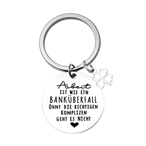 Close-up of stainless steel keychain with German quote and clover pendant detail