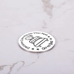 Macro detail of stainless steel decision coin with Go to Bed text and cartoon sleep icon