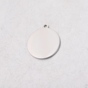 Macro detail of a blank stainless steel round pendant with a high-polished mirror finish