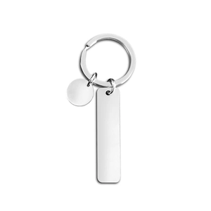 Close-up of polished stainless steel rectangular and round blank tags on keyring