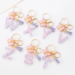 Purple glitter resin letter keychain with butterfly pendant and leather tassel charm