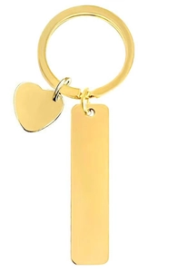 Close-up of polished gold stainless steel rectangle and heart pendants for DIY engraving