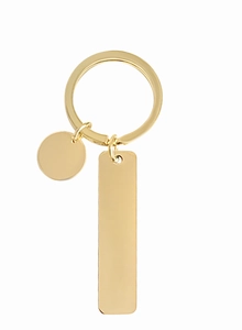 Close-up of a polished gold rectangular and circular metal keychain with a shiny finish