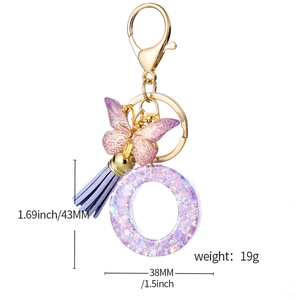 Purple glitter resin letter O keychain with butterfly charm and leather tassel for bags