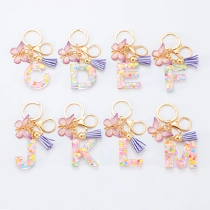 Porte-clés lettres en résine violette avec paillettes, papillon et pompon en cuir