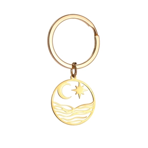 Close-up of gold stainless steel keychain featuring celestial moon and wave patterns