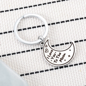 Polished stainless steel moon keychain engraved with I Love You To The Moon and stars