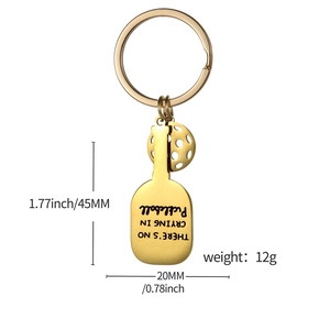 Golden pickleball racket keychain with hollow ball and motivational engraving