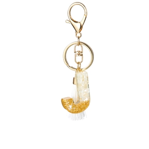 Detail of Letter J keychain with gold foil, white flakes, and a silk tassel pendant