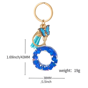 Blue glitter resin alphabet keychain with heart sequins, gold butterfly, and soft tassel