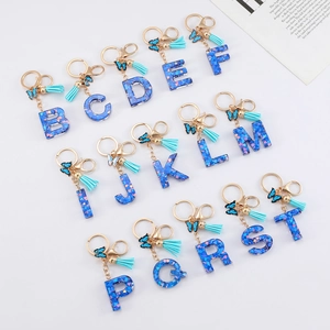 Blue resin alphabet keychain set with heart sequins, blue tassels and gold metal rings