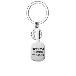 Detail of silver pickleball keychain with racquet pendant and engraved motivational quote