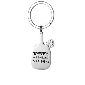 Close-up of pickleball paddle keychain with There's no crying in pickleball text