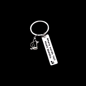 Silver stainless steel music keychain with G-clef and Where words fail music speaks engraving
