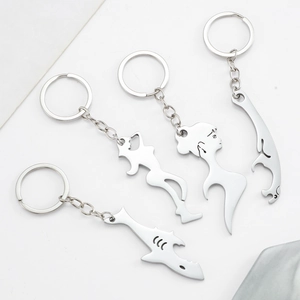 Set of four silver stainless steel keychain bottle openers with shark and dolphin shapes