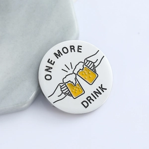 Round metal enamel coin with One More Drink cheering beers on hexagonal stone