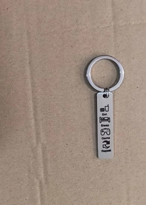 Detail shot of Eat Sleep Game Repeat engraved stainless steel gaming keychain tag