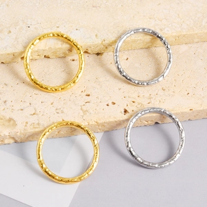 Detail of 18k gold and silver stainless steel rings with unique hammered texture