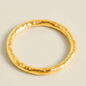 Detailed macro view of 18k gold plated stainless steel ring with hammered texture finish