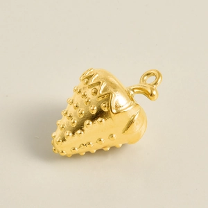 Detailed view of a gold-plated strawberry pendant with textured surface for DIY jewelry