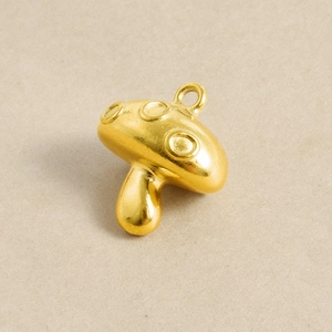 Detail of mushroom shaped gold stainless steel pendant for DIY jewelry making