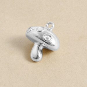Close-up of a 304 stainless steel mushroom pendant with circle details for DIY jewelry