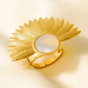 Detail of 18k gold plated fan-shaped ring with white shell inlay on beige silk