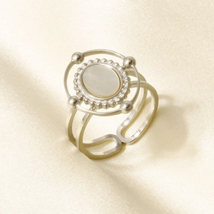 Detail of adjustable stainless steel ring with oval white shell inlay and beaded edges