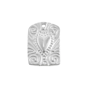 Detailed macro view of silver heart relief pendant with ornate bohemian scrollwork patterns
