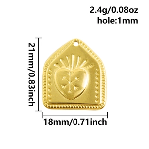 Macro view of gold heart pendant with snowflake pattern engraving and dimensions
