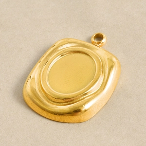 Macro detail of square 304 stainless steel gold pendant base with oval setting groove