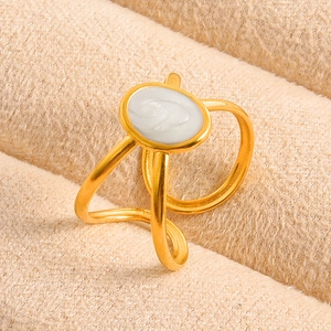 Macro shot of gold vintage ring featuring a white oval elephant relief on plush fabric