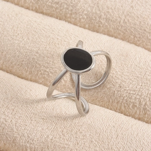 Macro shot of silver minimalist geometric ring with black oval enamel detail and open band