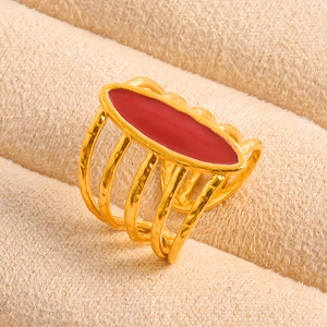 Detailed close-up of 18K gold-plated ring featuring red enamel inlay and textured band