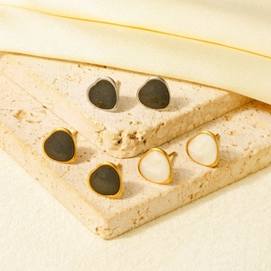 Three pairs of heart stud earrings in gold and silver finish with black and pearl inlay
