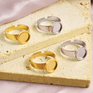 Detailed macro of gold and silver stainless steel adjustable ring bases on stone