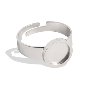 Detailed view of silver tone adjustable open ring with a flat round bezel setting base