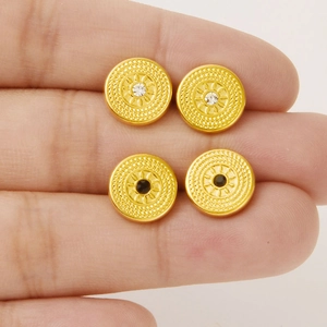 Retro gold circular stud earrings with textured finish and black or white crystal inlay