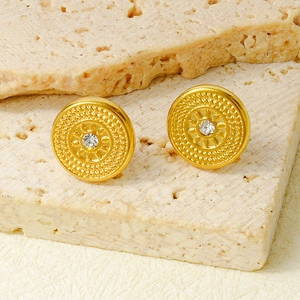 Vintage gold round stud earrings with geometric sunburst patterns and center crystal stone