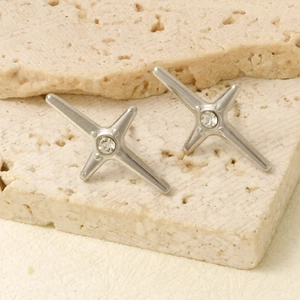 Détail de boucles d'oreilles étoile argentée avec cristal sur socle en pierre