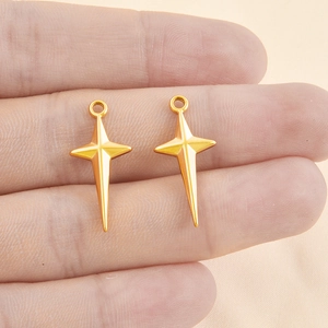 Polished 18k gold plated cross star charms for DIY necklace making held in hand