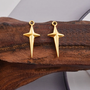 Detailed macro view of two minimalist 18k gold plated cross star charms for DIY jewelry