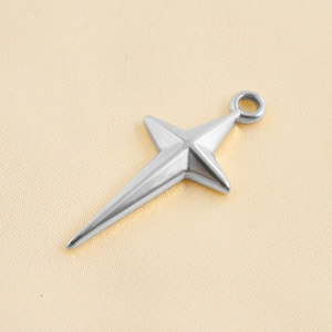 Macro shot of polished silver star pendant with mirror finish on beige silk fabric