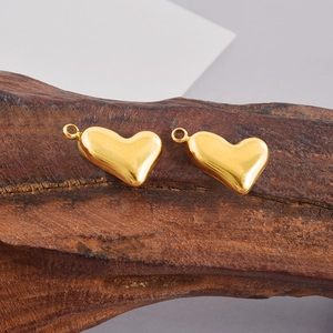 Close-up of golden 304 stainless steel heart pendants for DIY jewelry making