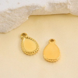 Golden teardrop stainless steel pendant with beaded edge texture and polished finish